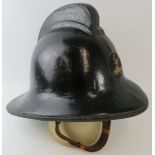 A 1970s British Hertfordshire Fire Brigade fire helmet with brass stag emblem.