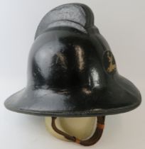 A 1970s British Hertfordshire Fire Brigade fire helmet with brass stag emblem.