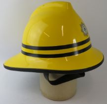 A 1990s British Cromwell Firepro yellow fire helmet with Leeds Bradford Airport badge