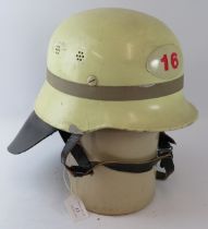 A 1970s West German Hamburg (16) Fire Service white steel helmet with leather neck cowl.