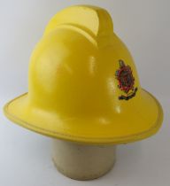 A 1980s British Peterborough Fire Brigade yellow fire helmet