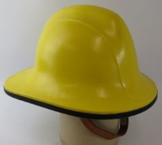 A 1990s British yellow trial fire helmet (unbadged)