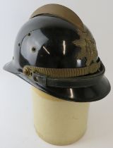 A 1980s Brazilian Fire Service black fireglass fire helmet with brass mounts