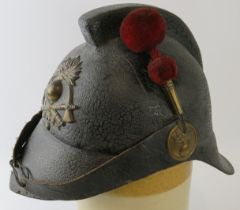 A rare early 20th century Argentine felt fire helmet with red felt side plume, circa 1910