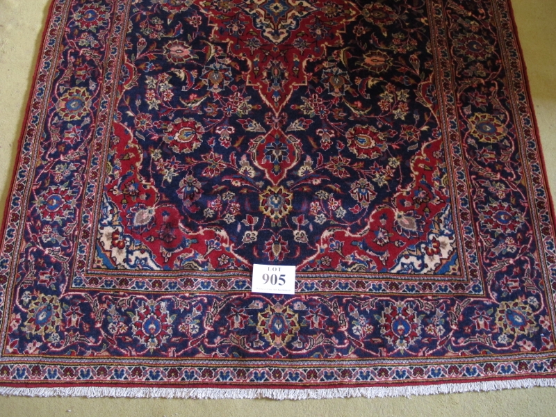 A central Persian Kashan rug. Typical Kashan with central motif. Red on blue ground. 230cm x