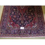 A central Persian Kashan rug. Typical Kashan with central motif. Red on blue ground. 230cm x