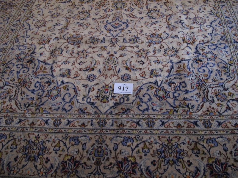 A fine central Persian Kashan carpet. A 16 point central motif on cream ground, surrounded by