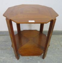An Art Deco Period walnut octagonal two-tier table, the quarter veneered top with swing-out brass