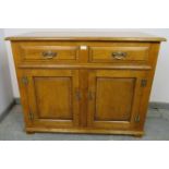 A good quality solid oak sideboard in the 18th century taste, housing two short oak-lined drawers