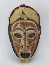 Tribal Art: A West African carved and painted wood mask, possibly Ivory Coast. 42 cm height.