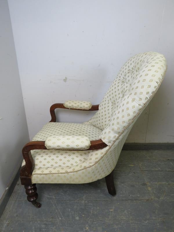 A Victorian mahogany open-sided button backed armchair, upholstered in patterned cream material, - Image 2 of 4
