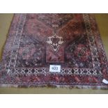 A 20th Century Qashqai rug. Central pointed medallion on a red/pink ground bordered in cream. 158