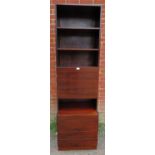 A mid-century Danish hardwood tall drinks cabinet, having three open shelves above a fall-front