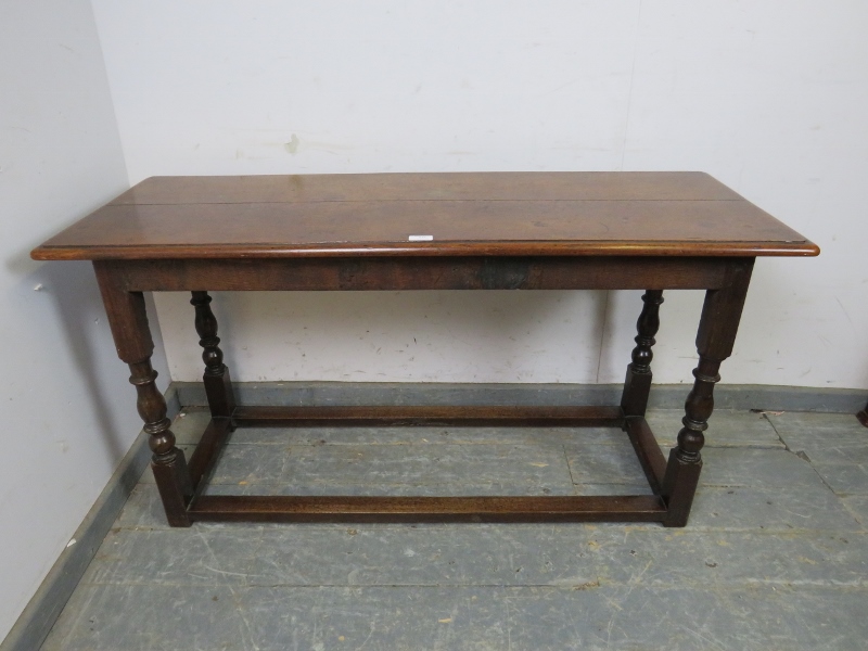 A 19th century oak serving table, on turned and block supports with stretchers. H68cm W129cm