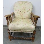 An antique Continental beech and ash wheelback reclining armchair, having carved and pierced sides