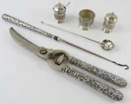 A pair of white metal handled poultry shears, a similar button hook, three piece Eastern cruet and