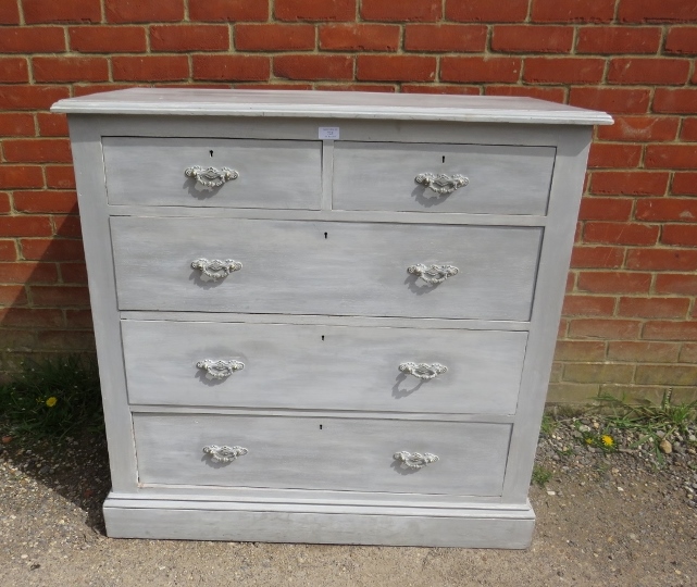 An oak chest, painted grey and distressed, housing two short above three long graduated