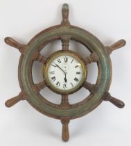 Maritime: A Sestrel bulkhead clock set within an oak and brass six spoke ship’s wheel, 20th century.
