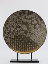 A large African white metal ornamental plate on a stand, late 20th century. 47 cm diameter.