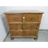 A 17th century and later oak chest housing three long drawers with split moulded geometric