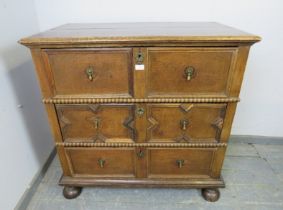 A 17th century and later oak chest housing three long drawers with split moulded geometric