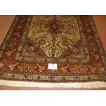 North West Persian Tabriz rug, central motif surrounded by foliage on cream/brown field. 182cm x