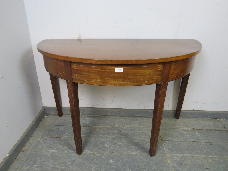 A George III mahogany demi-lune console table, strung with satinwood and boxwood, on tapered