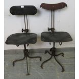 A pair of early 20th century height-adjustable machinist’s stools, also having height-adjustable