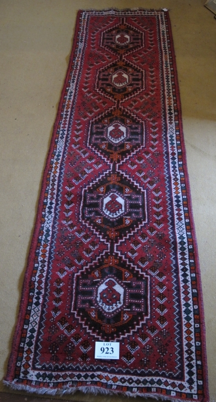 A mid 20th Century Turkish runner. Five central interlocking medallions on a red ground 290 x - Image 2 of 3