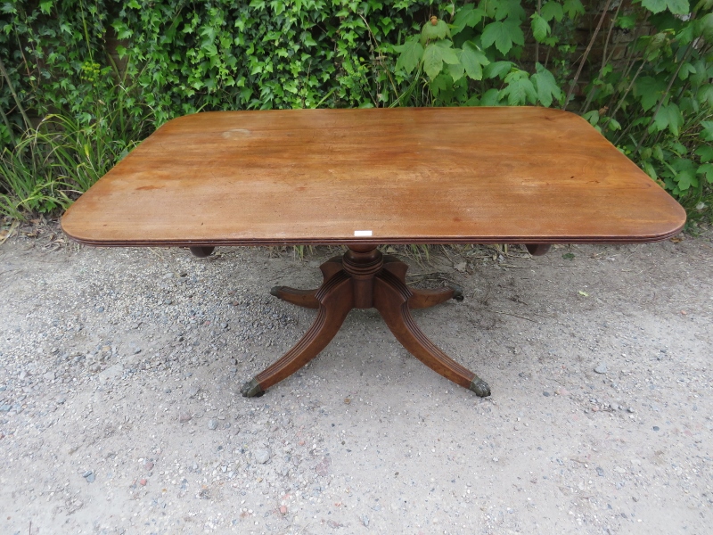 A Regency Period mahogany tilt-top breakfast table, the rectangular top with reeded edge, on a