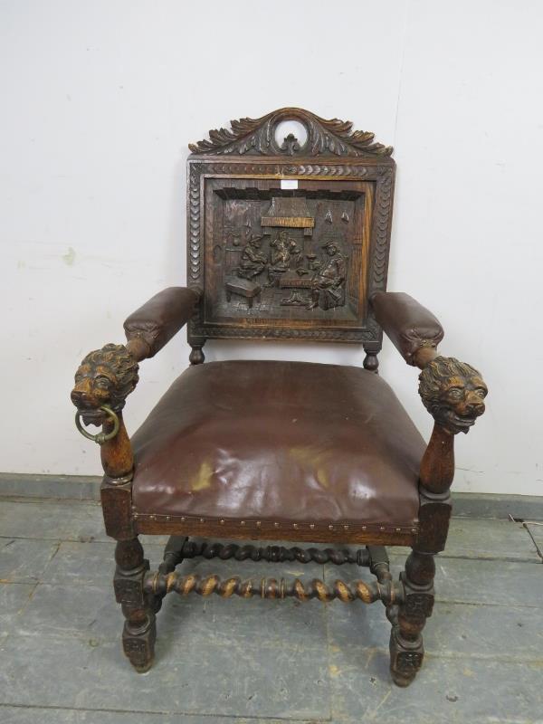 A 19th century oak throne chair, the acanthus carved cornice above a back panel with relief carved
