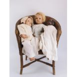 Three vintage dolls and a wicker chair. (4 items) Chair: 68.7 cm height. Condition report: Some