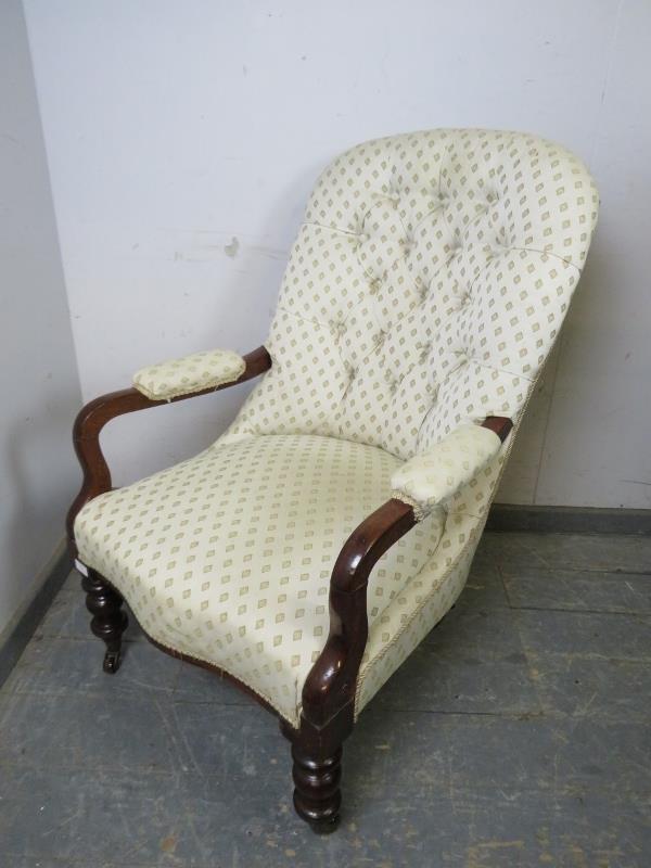 A Victorian mahogany open-sided button backed armchair, upholstered in patterned cream material, - Image 4 of 4