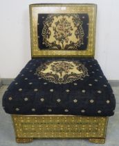 A highly decorative ottoman seat, upholstered in navy material with tapestry decoration, the back
