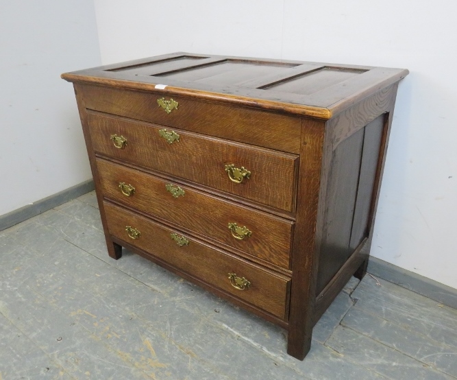 An antique oak chest in the 18th century taste, the panelled lid opening onto a shallow compartment, - Image 2 of 3