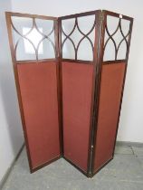 An Edwardian mahogany 3-section folding modesty screen, the glazed upper section with tracery