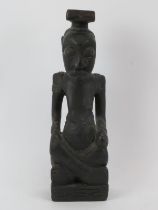 Tribal Art: An African carved and ebonised wood seated figure, Congo. 35 cm height. Condition