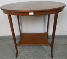 An Edwardian mahogany oval occasional table, crossbanded and parquetry strung, on tapering square