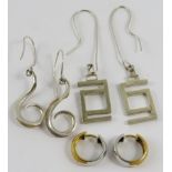 Two pairs of Artisanal white silvery metal earrings, of scroll or linear design, and another pair of