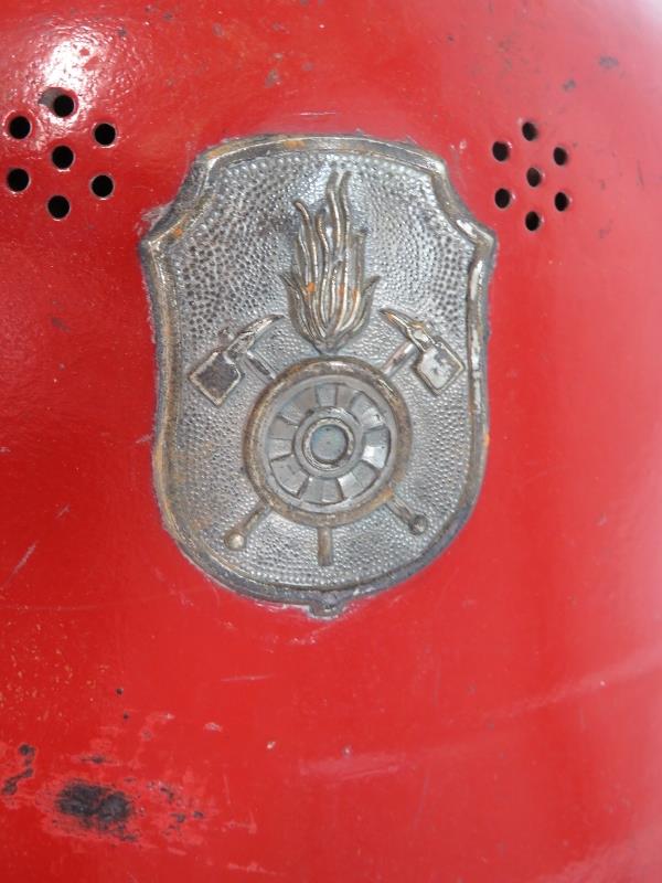 A 1950s West German red steel fire helmet with side mounted badge - Image 2 of 4