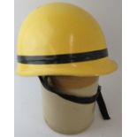 A late 20th century Goa Fire Service yellow fibreglass fire helmet with Concord Arai label