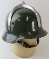 A 1950s German style Hungarian Fire Service steel fire helmet with polished metal mount