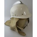 A 1970s Dutch Fire Service white fibreglass fire helmet with white metal comb and wraparound neck