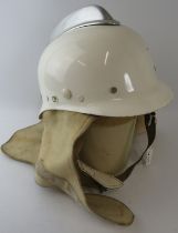 A 1970s Dutch Fire Service white fibreglass fire helmet with white metal comb and wraparound neck