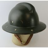 A 1970s Romanian Fire Service green painted fibreglass fire helmet.