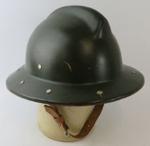 A 1970s Romanian Fire Service green painted fibreglass fire helmet.