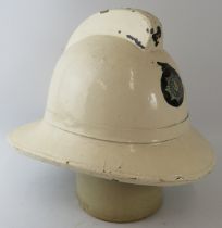 A 1970s British Fire Services Assurance white cork fire helmet