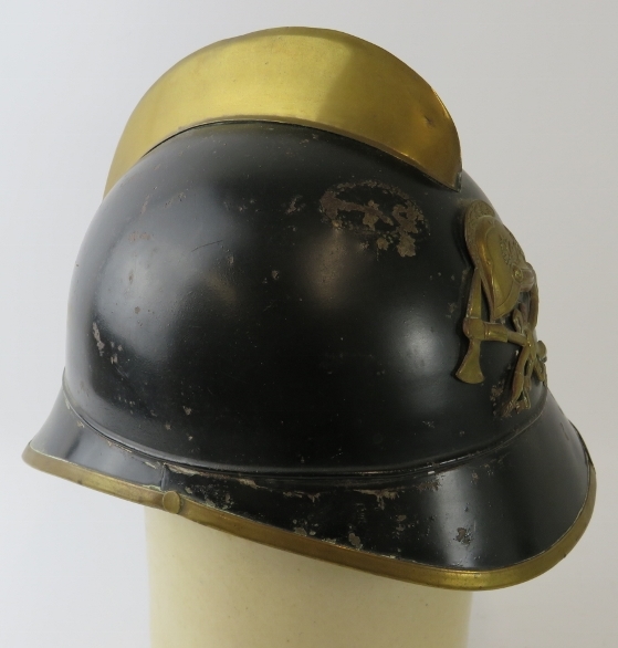 A 1930s German black and brass fire helmet with crossed axe badge - Image 2 of 4