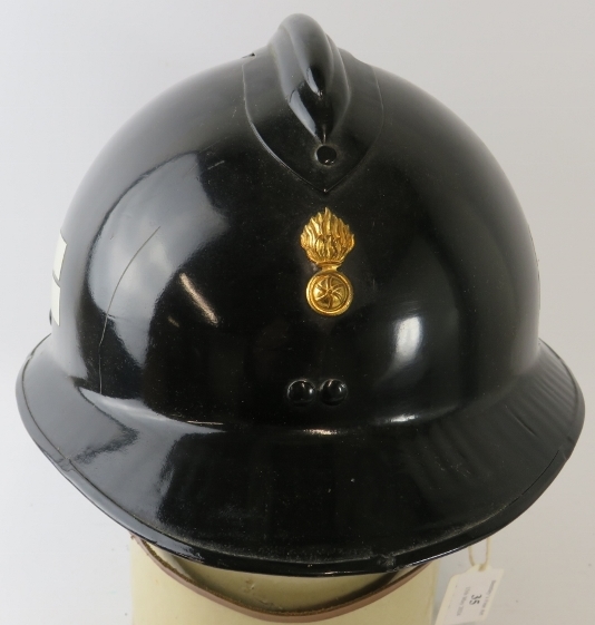 A 1970s Luxumberg Fire Service black steel fire helmet with brass badge. - Image 2 of 3