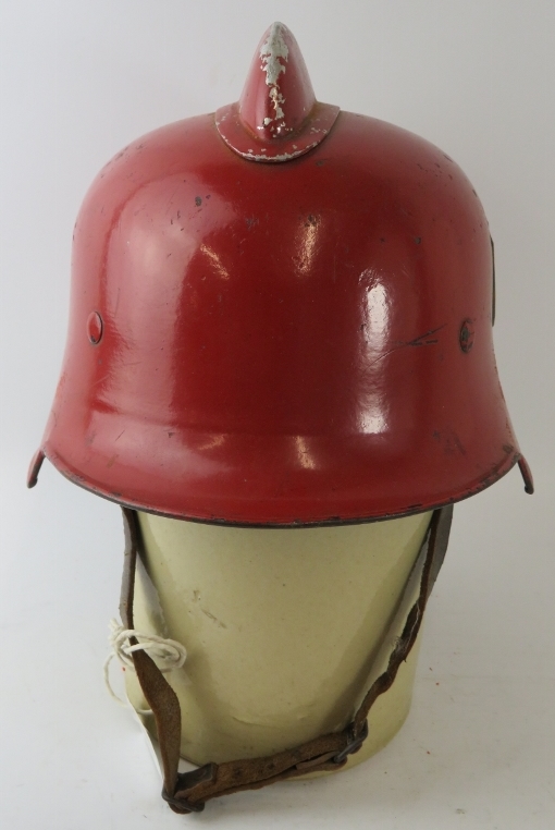 A 1950s West German red steel fire helmet with side mounted badge - Image 3 of 4